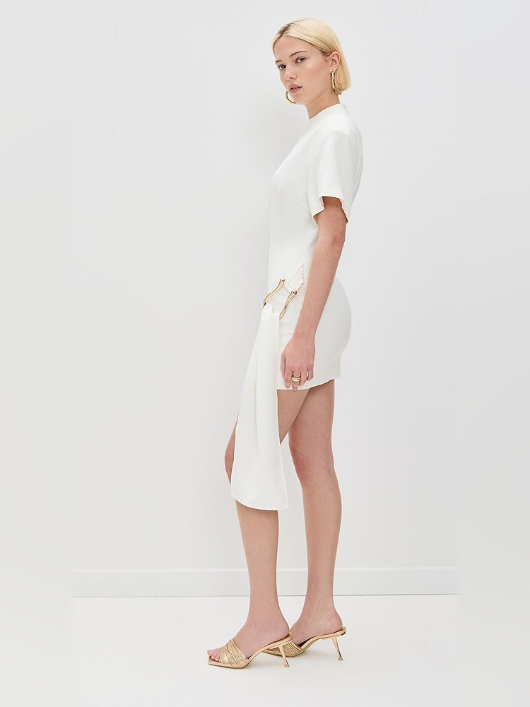 White mini dress side view with asym drape, short sleeves and heels