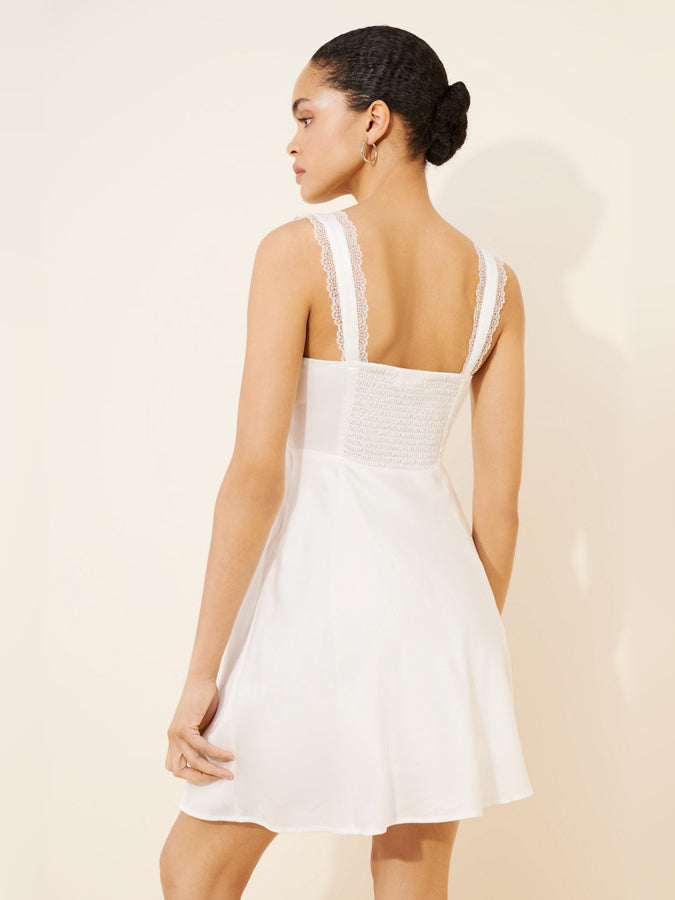 White lace-trim mini dress with open back and thin straps, back view