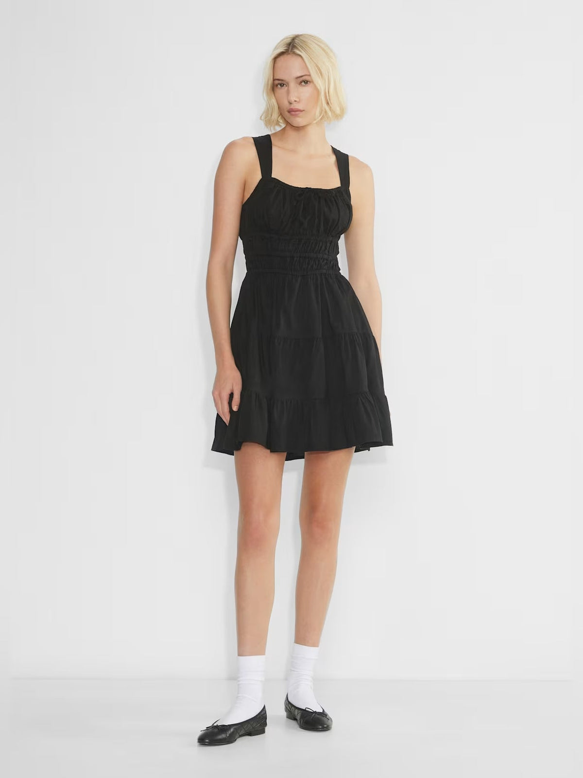 Black tiered mini dress with square neckline and thin straps