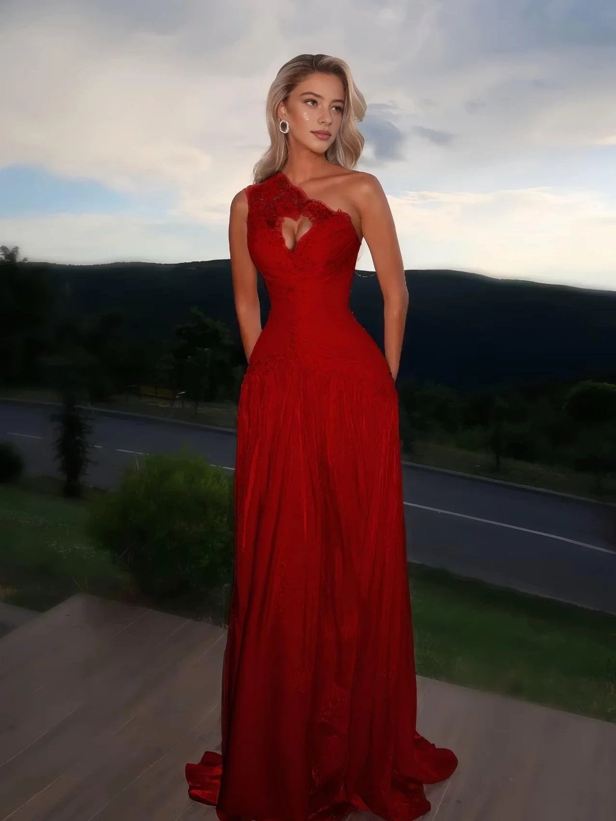 Burgundy one-shoulder prom dress with ruched bodice, floral heart applique, and flowy A-line hem
