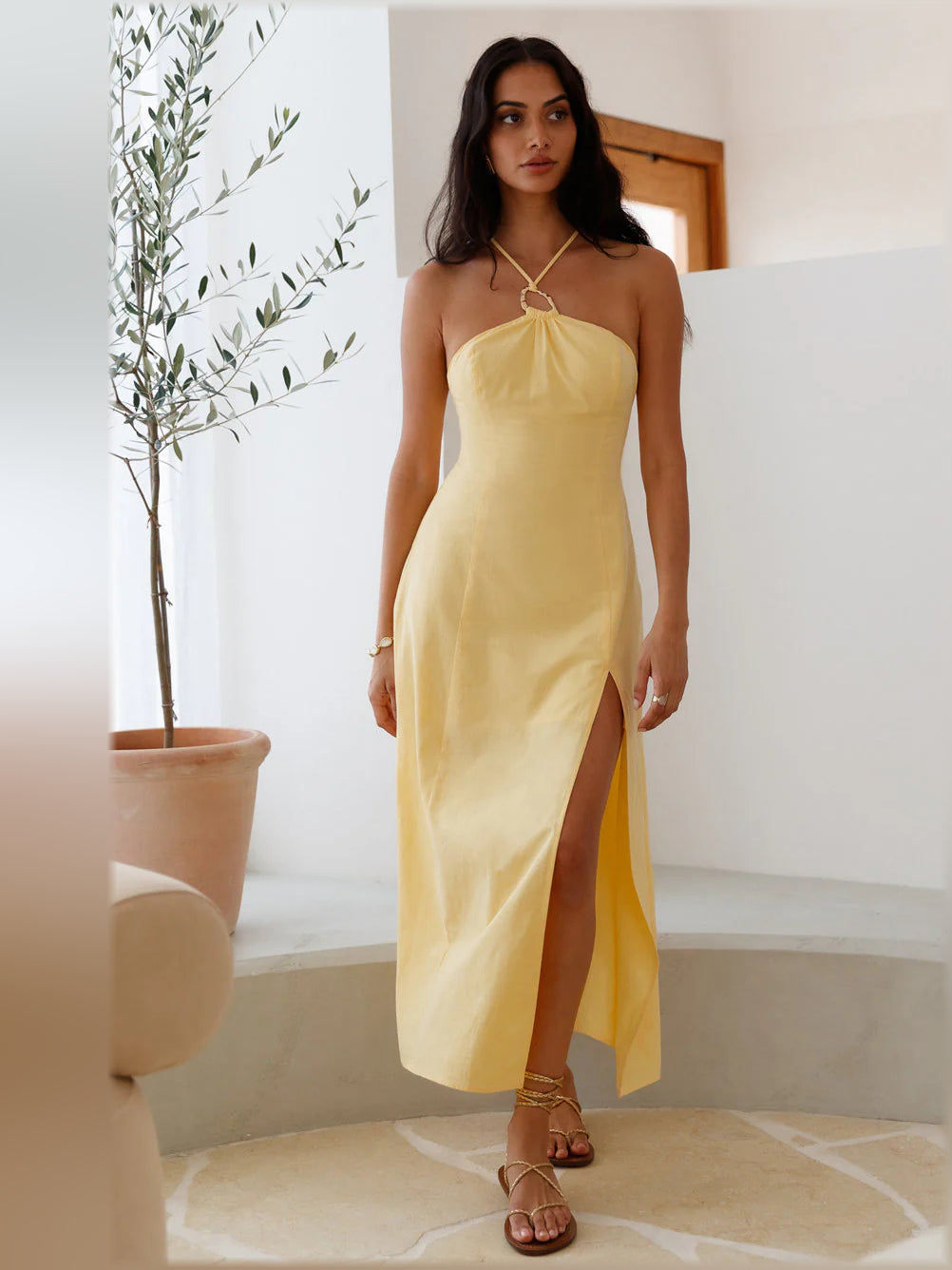 Yellow halter midi formal dress with flowing skirt, front slit, tie-neck detail