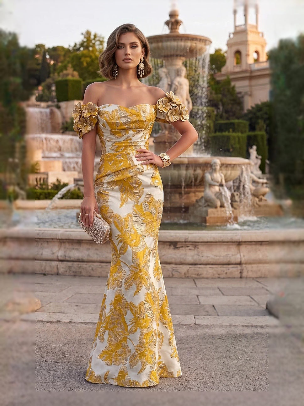 Yellow off-shoulder mermaid gown with ruched bodice and floral applique