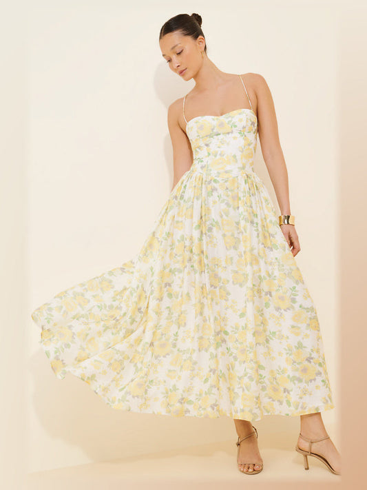 Light yellow floral A-line midi dress with thin spaghetti straps and full gathered skirt