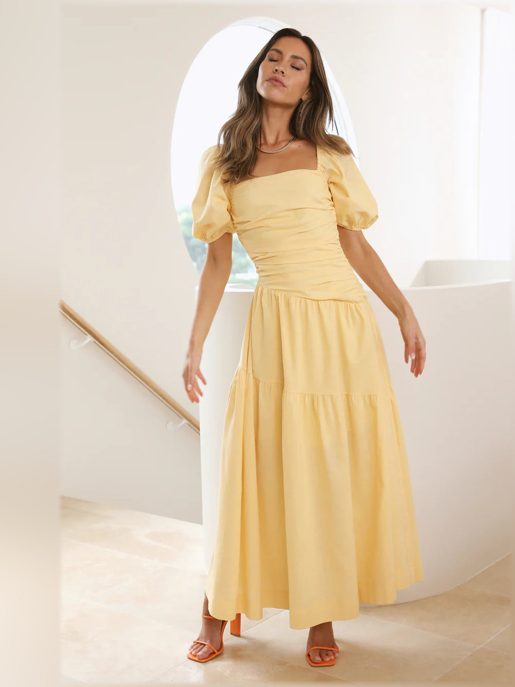Yellow midi formal dress with ruched waist, puff sleeves, and tiered skirt