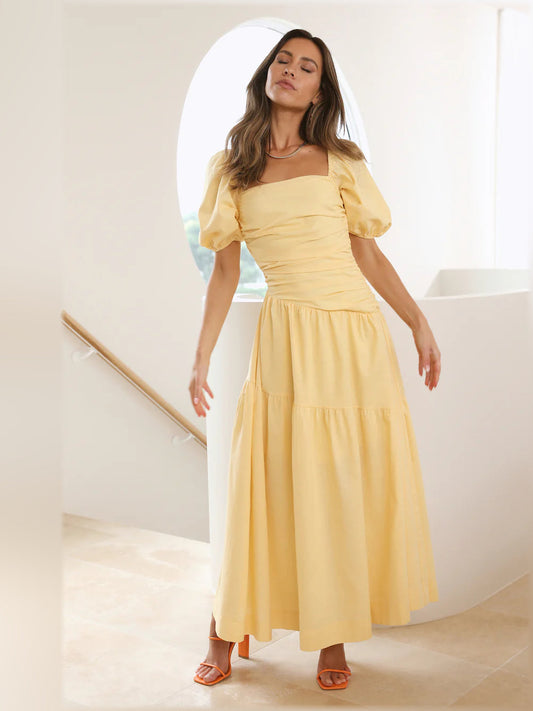 Yellow midi formal dress with ruched waist, puff sleeves, and tiered skirt