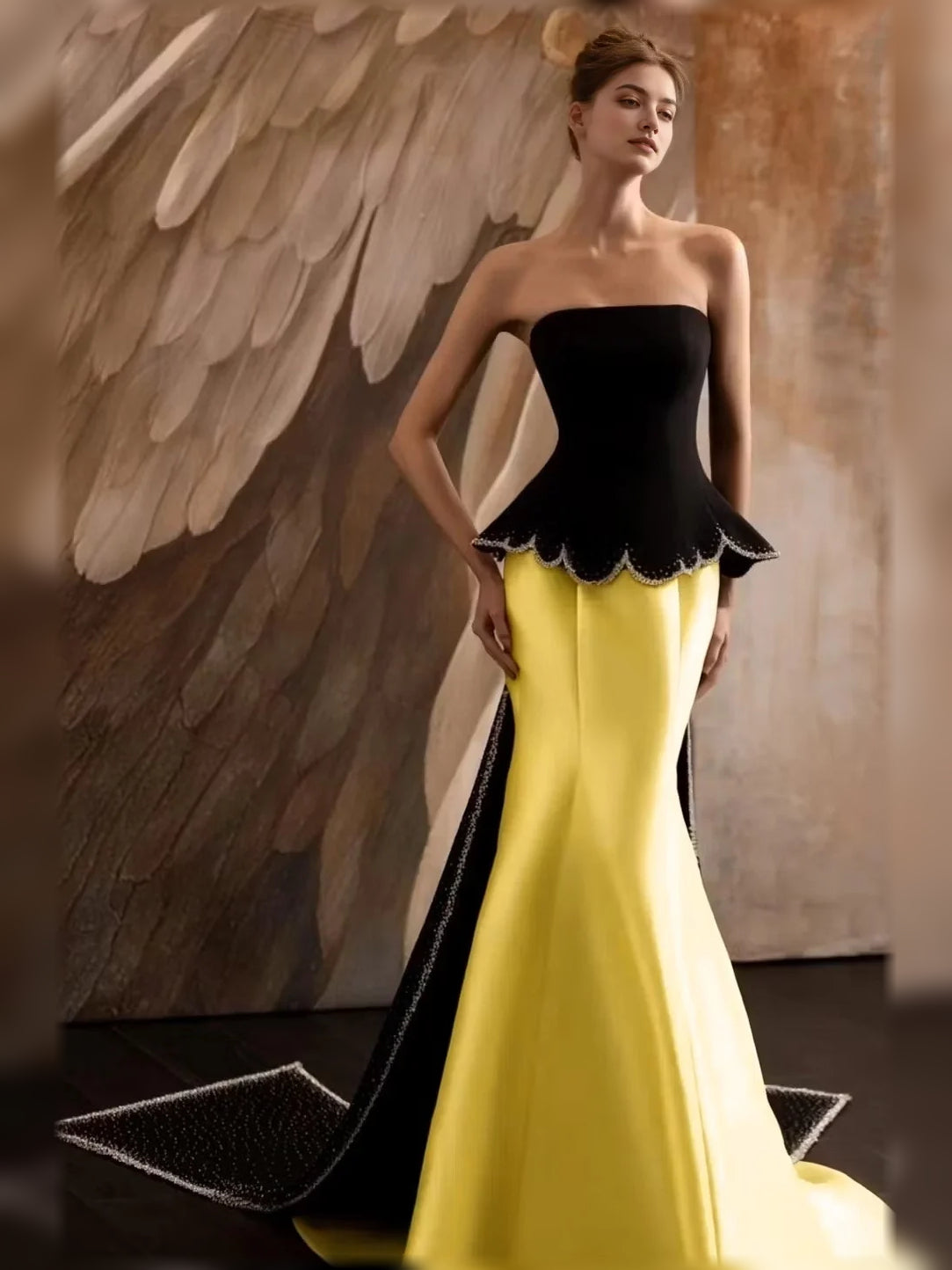 Yellow strapless mermaid formal dress with black scalloped peplum bodice