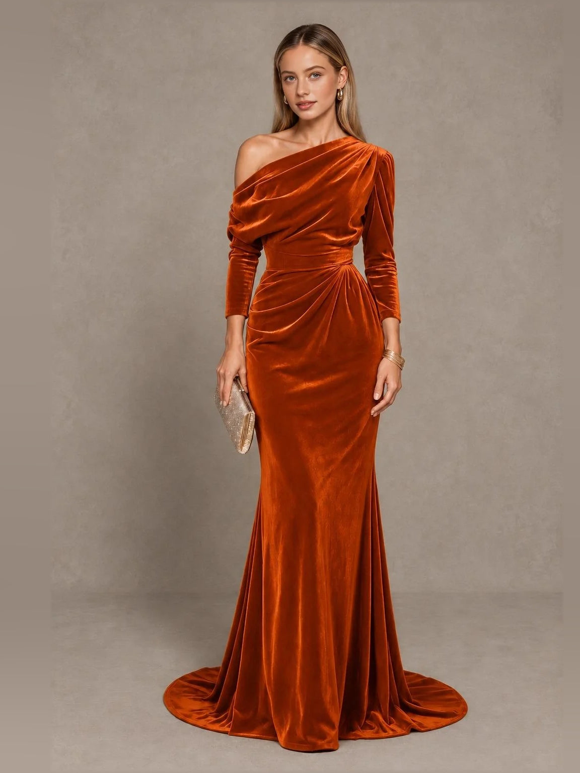 Burnt orange velvet one-shoulder mermaid gown with draped bodice and long sleeves