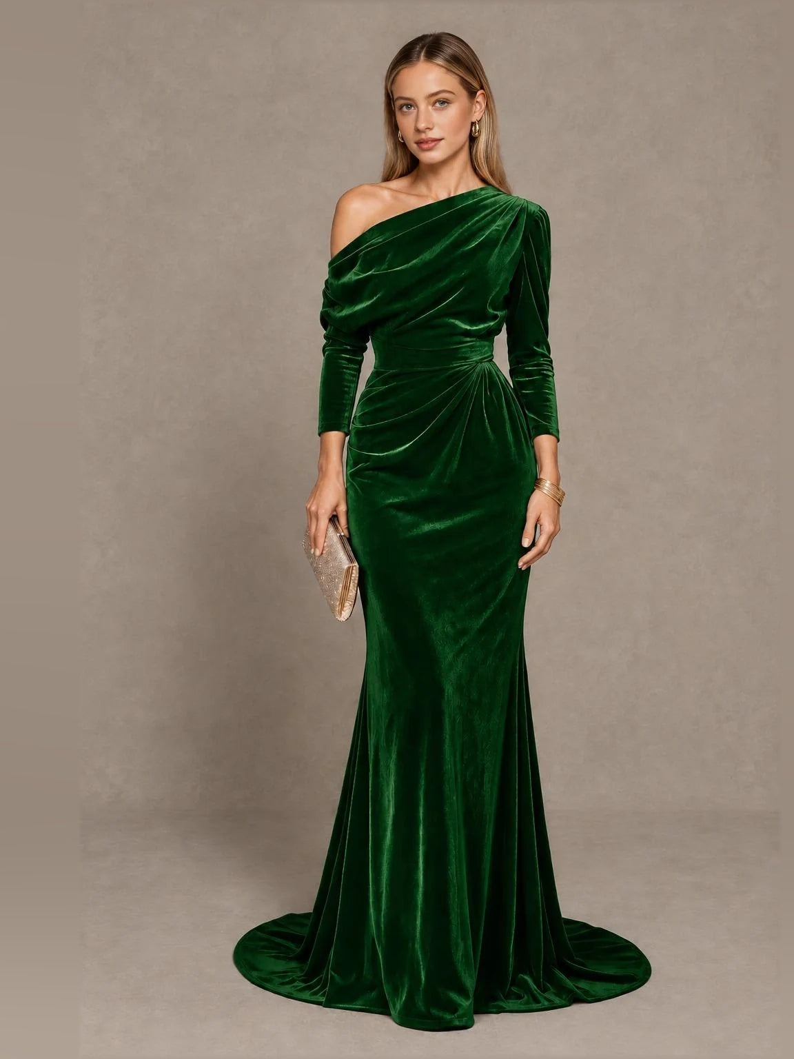 Emerald green velvet one-shoulder mermaid gown with draped bodice and long sleeves