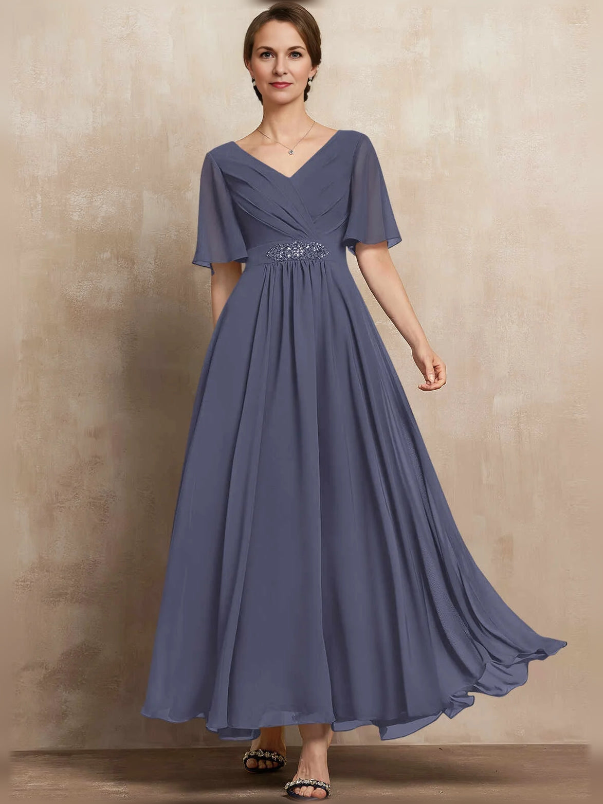 Periwinkle blue chiffon maxi dress with V-neck, pleated A-line skirt, flutter sleeves, and beaded waist