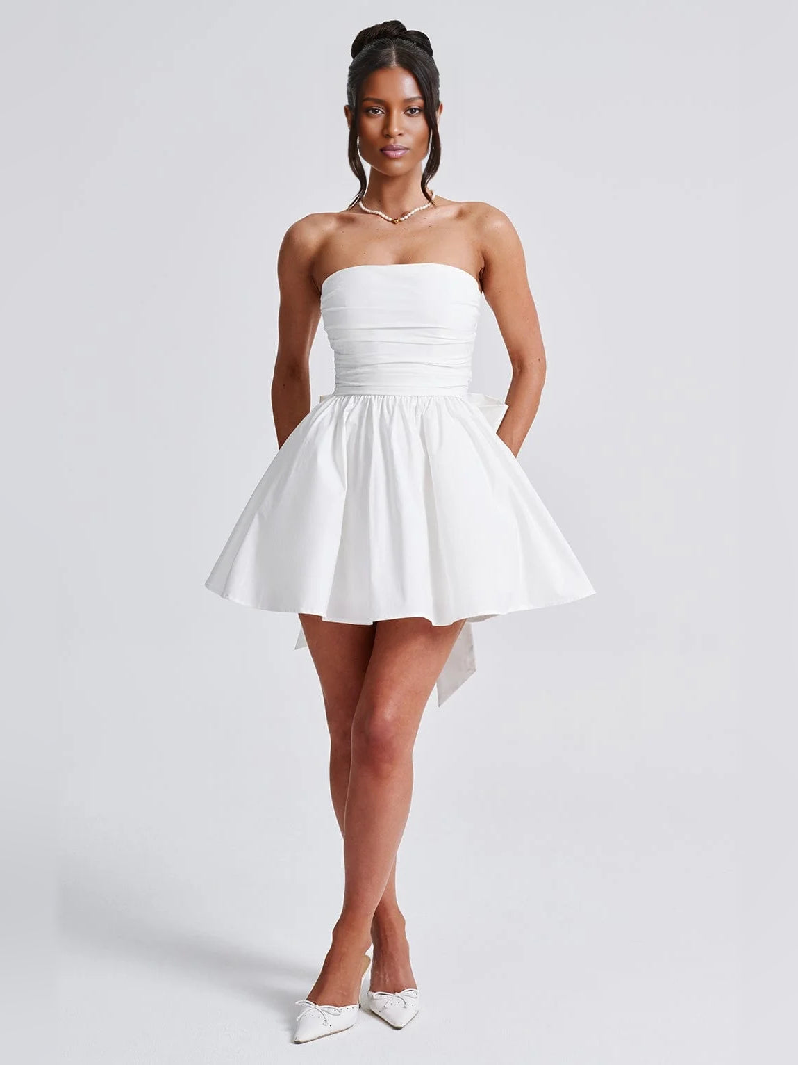 White strapless A-line mini tulle dress with ruched bodice and flared skirt