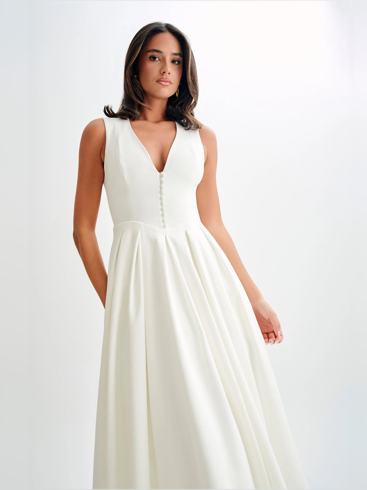 White sleeveless midi formal dress with deep V-neck and center button trim detail