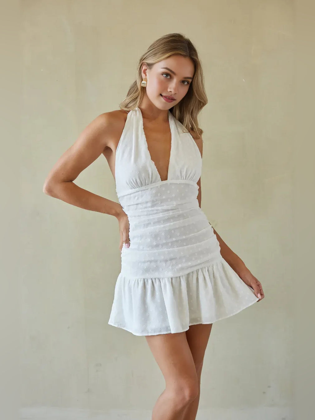 White sleeveless ruched V-neck mini A-line dress with ruffled waist and skirt