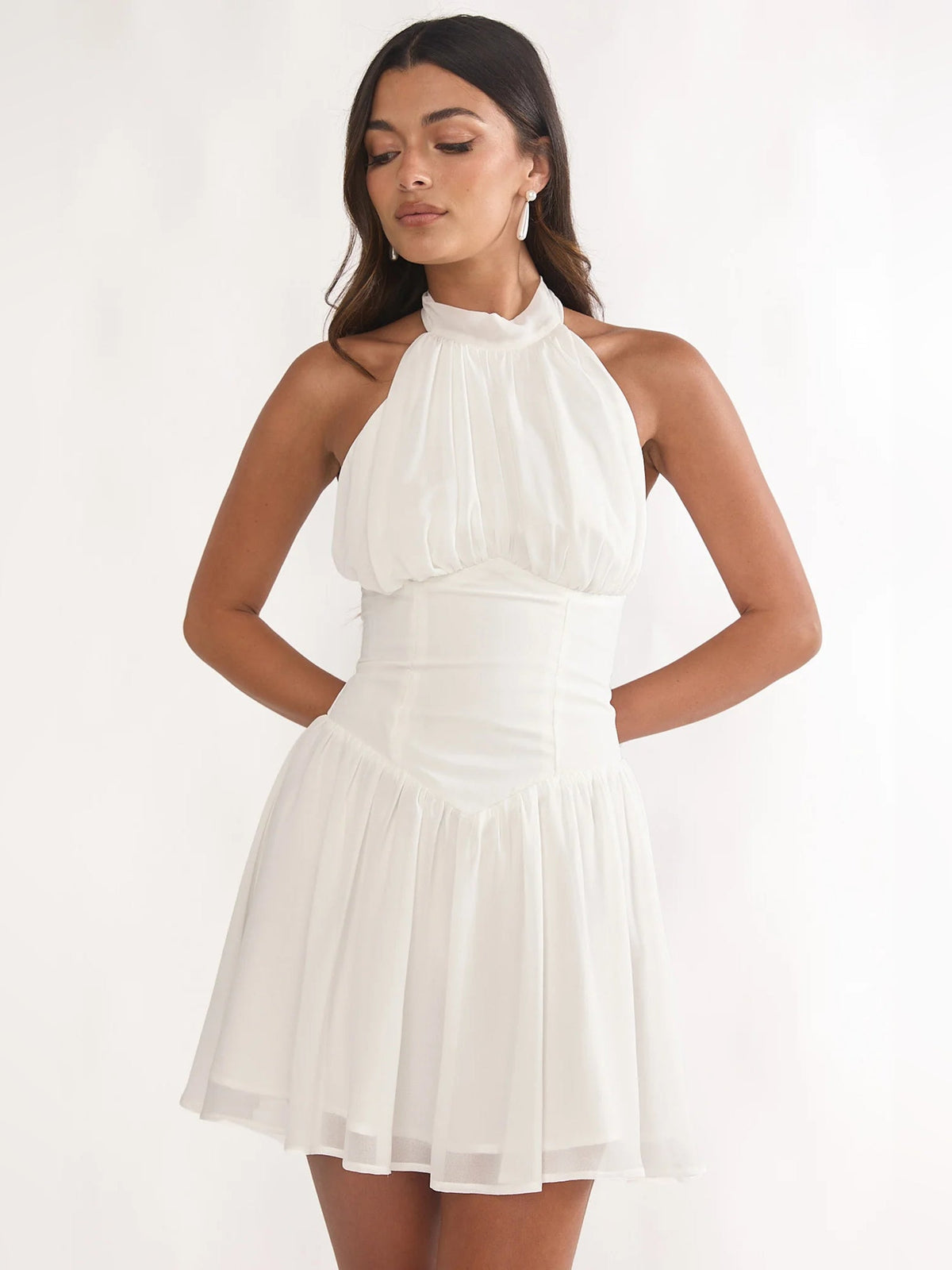 White high-neck halter mini dress with pleated skirt tiers and fitted waist
