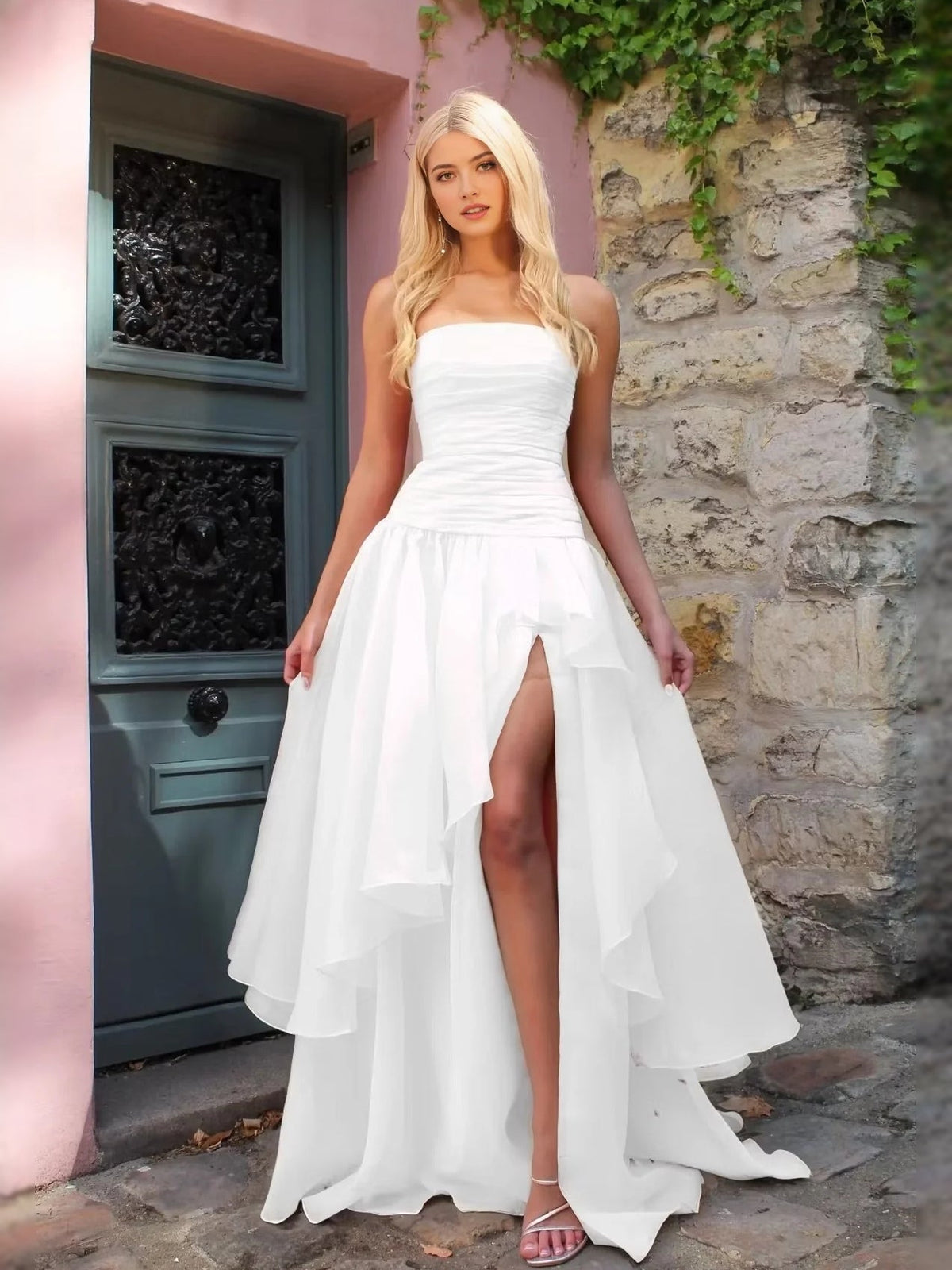 White strapless A-line prom dress with ruched bodice and high-low front slit hem