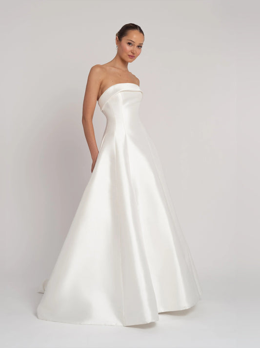 Ivory strapless satin wedding dress with fitted waist and A-line flare skirt
