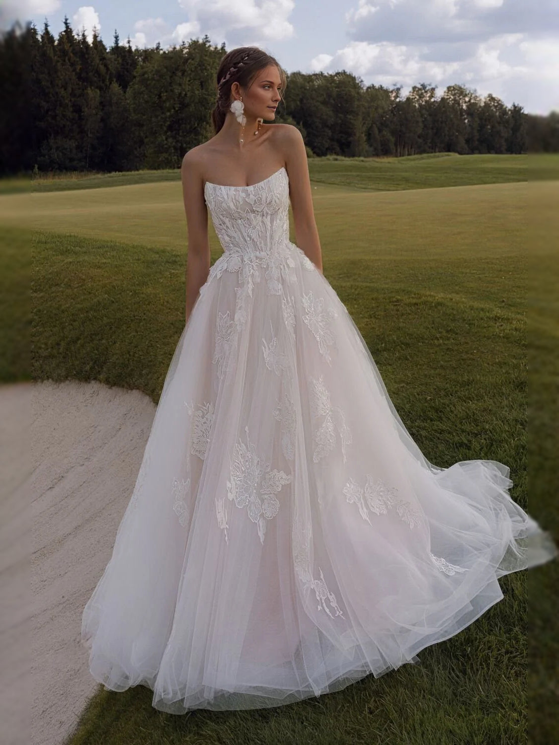 Ivory tulle A-line wedding dress with sweetheart corset bodice and cascading tulle skirt