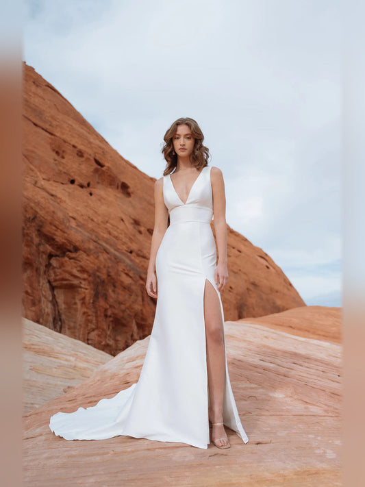 Ivory sleeveless deep V-neck A-line gown with thigh slit and long hem