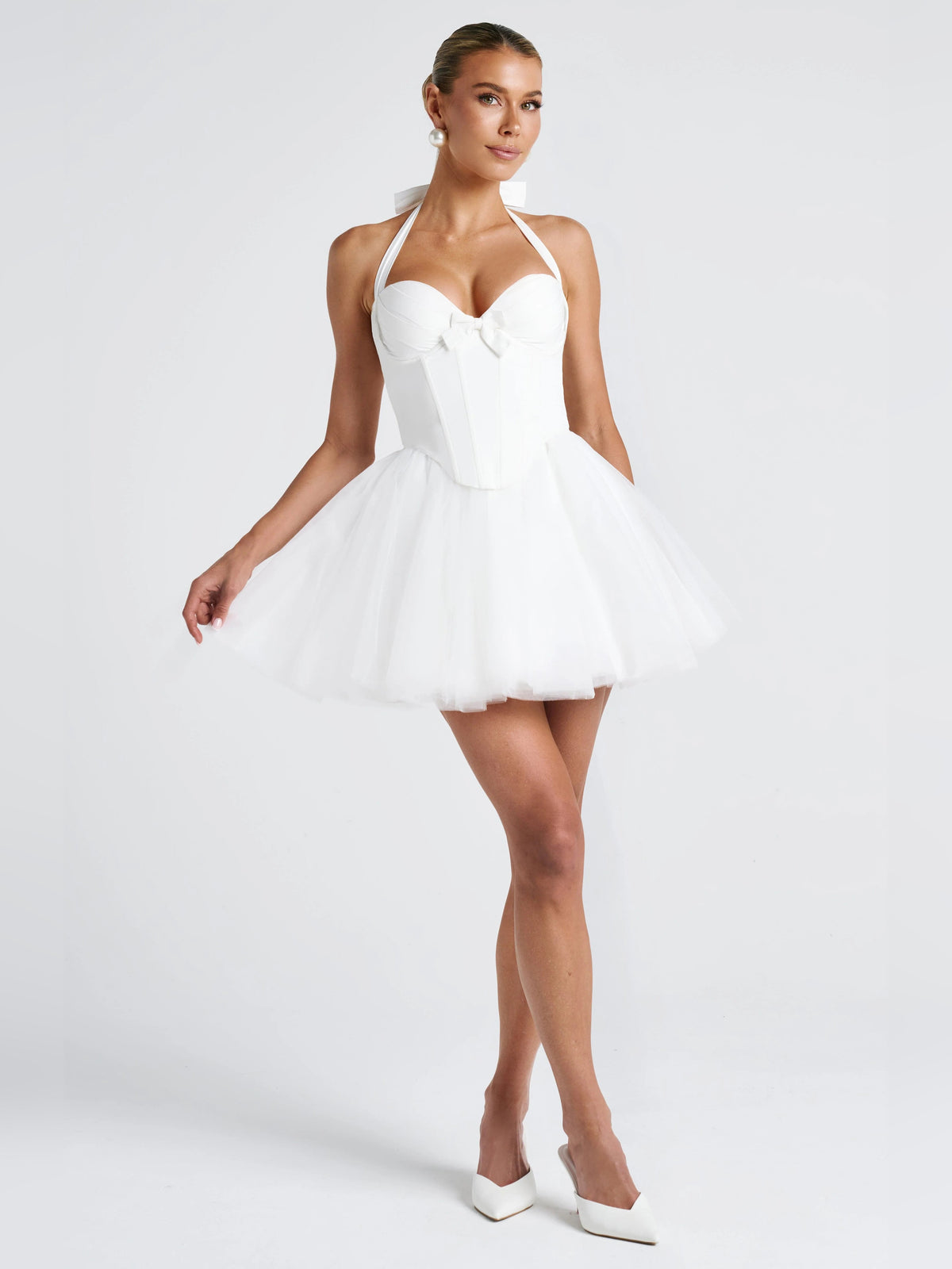 Ivory mini homecoming dress front view with halter bow bodice and tiered tulle skirt