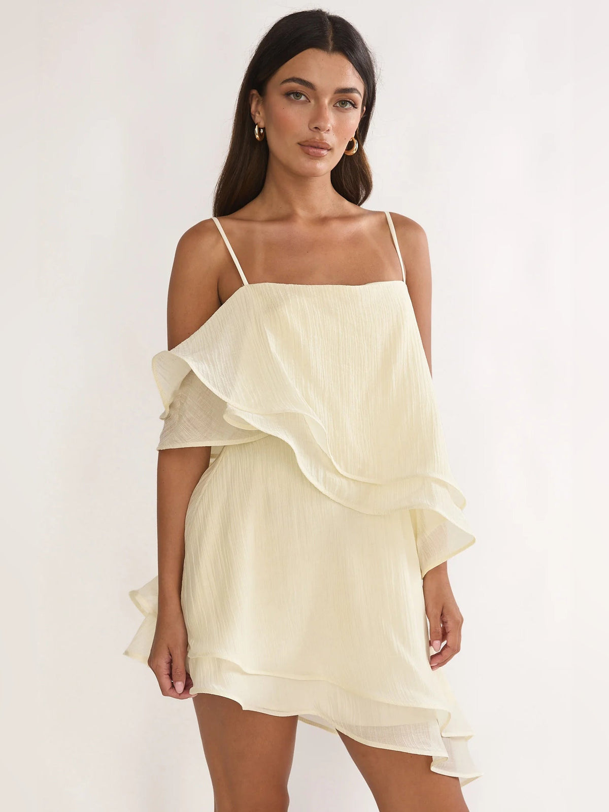 Cream asymmetrical mini dress with layered ruffle skirt and spaghetti straps