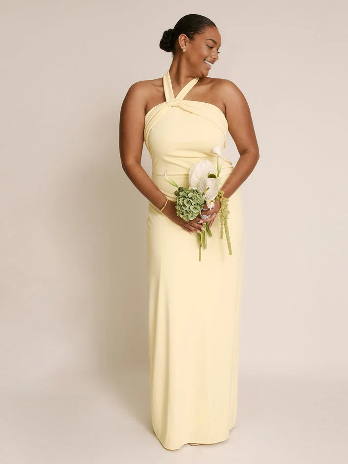 Lemon yellow floor-length halter sheath dress with twisted halter and bow-tie back