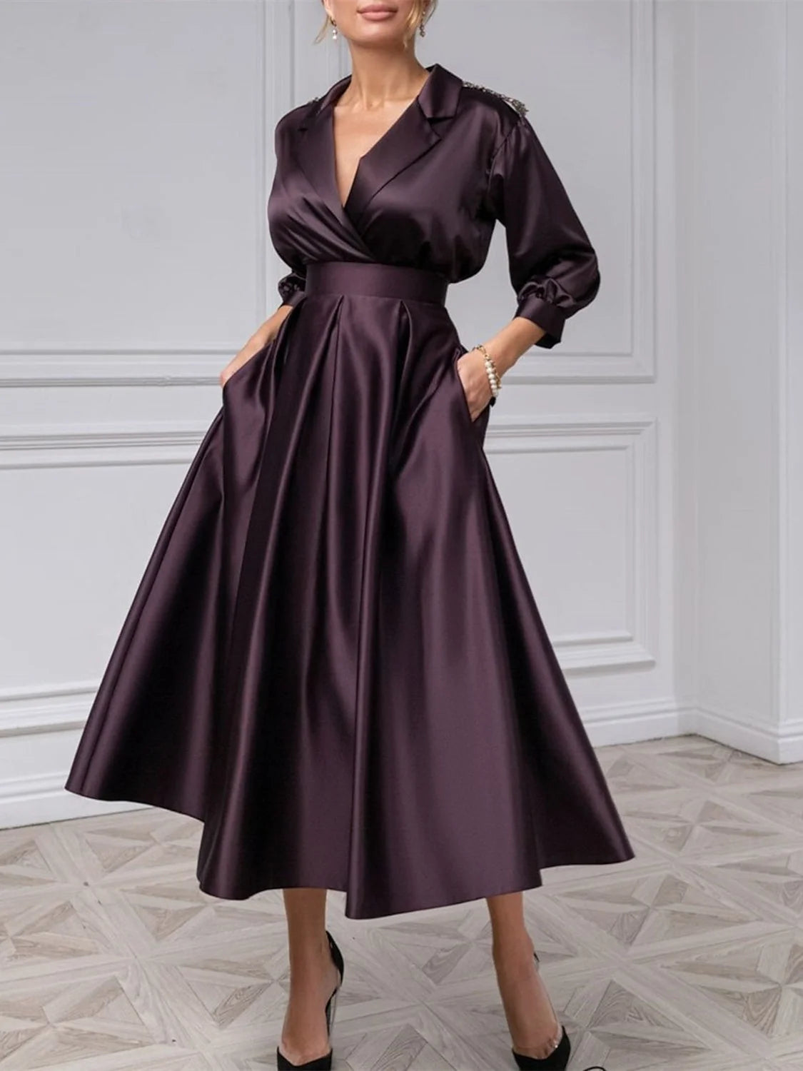 Deep purple satin midi dress with draped V-neck, long puff sleeves, and flared pleated skirt