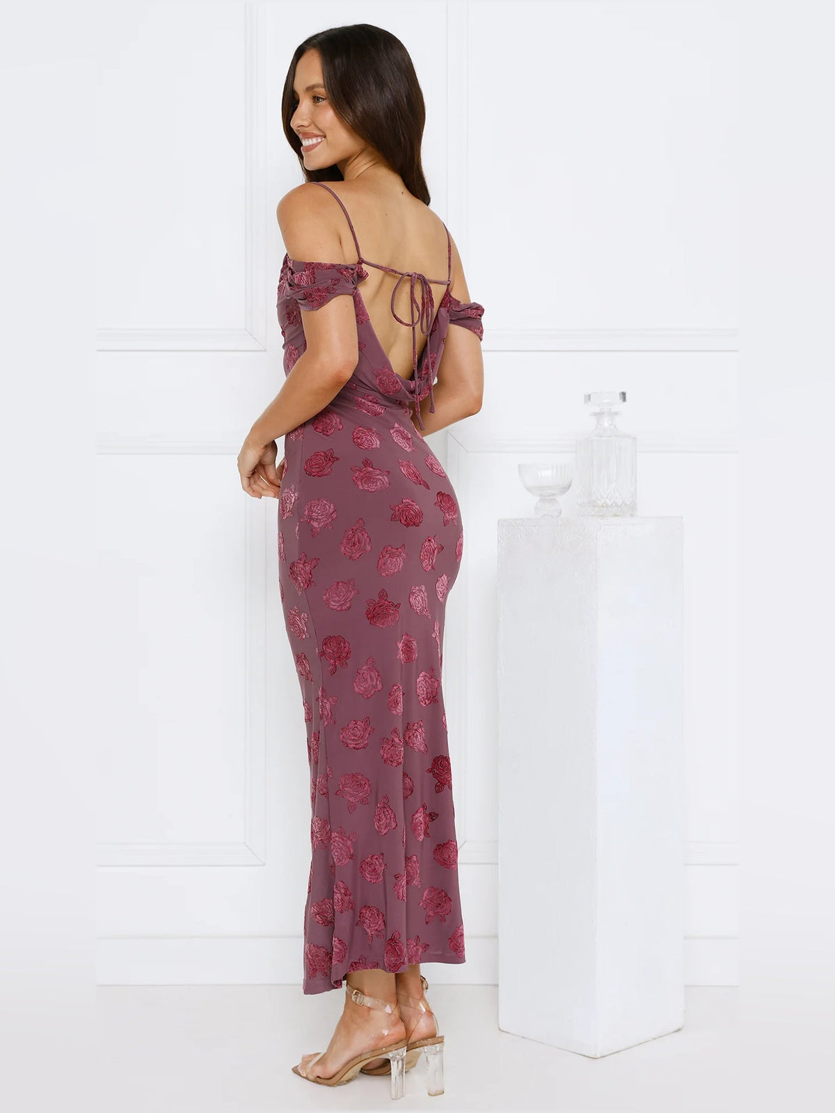 Side back view of maroon floral off-shoulder maxi sheath dress with lace-up details