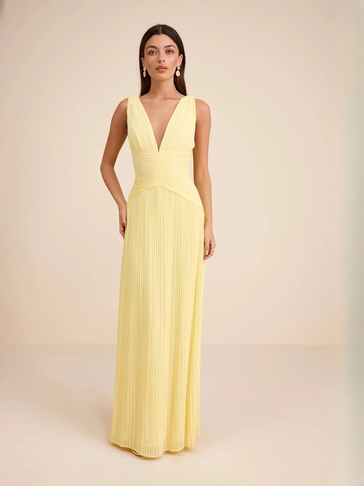 Light yellow V-neck tiered maxi dress with ruched bodice and pleated chiffon skirt