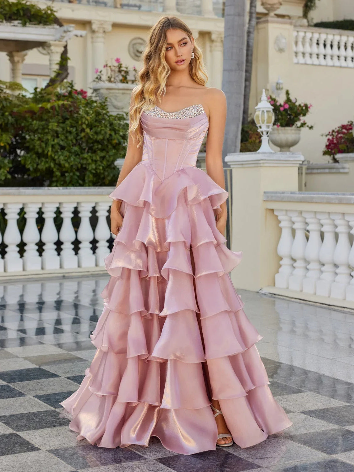 Light pink tiered sweetheart ball gown with corset bodice and layered ruffle skirt