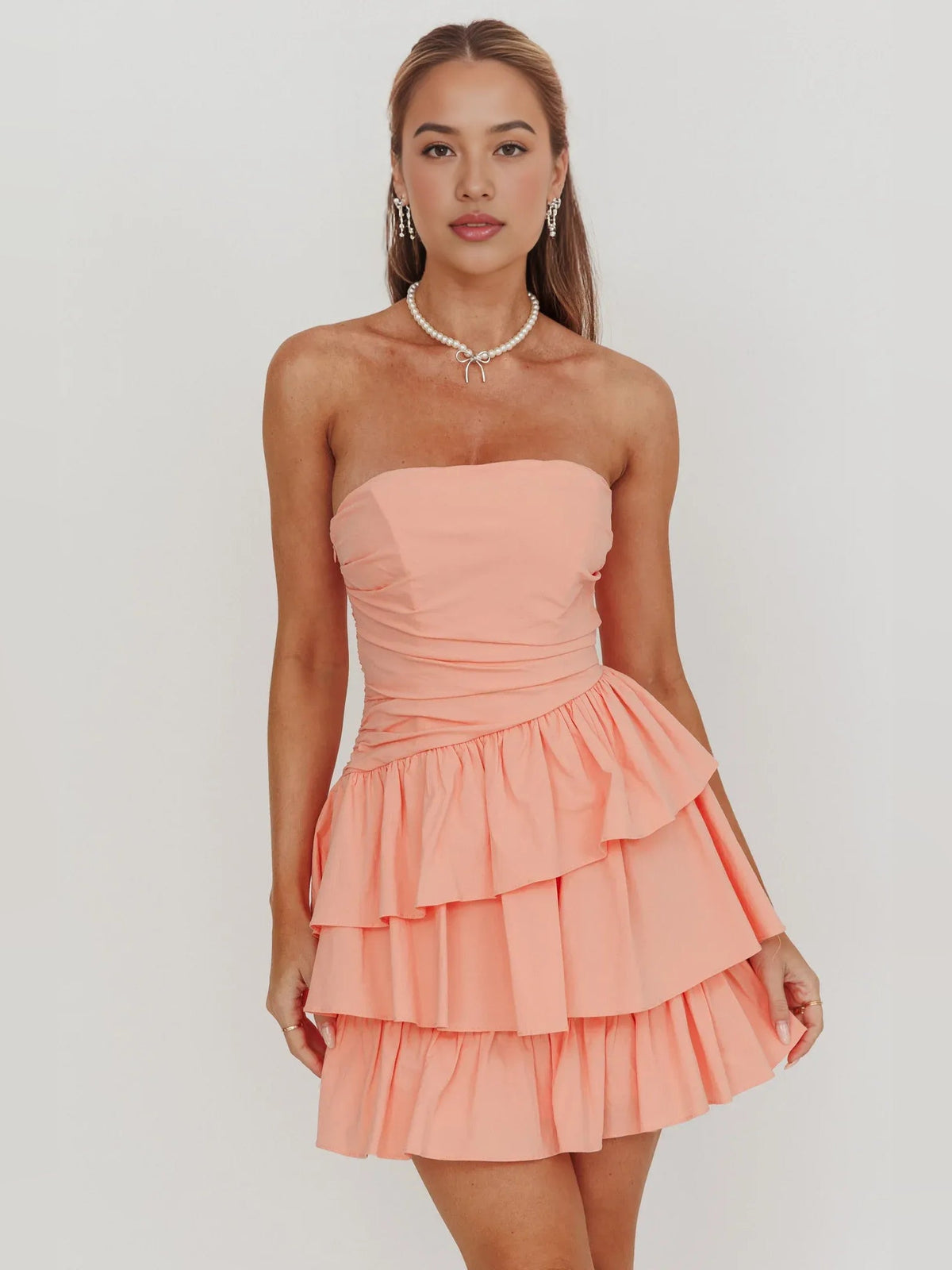Coral strapless ruched mini dress with tiered ruffle skirt