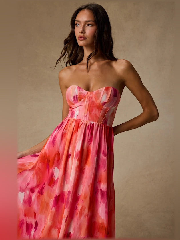 Coral pink abstract strapless bustier midi formal dress, front close-up with hand on hip
