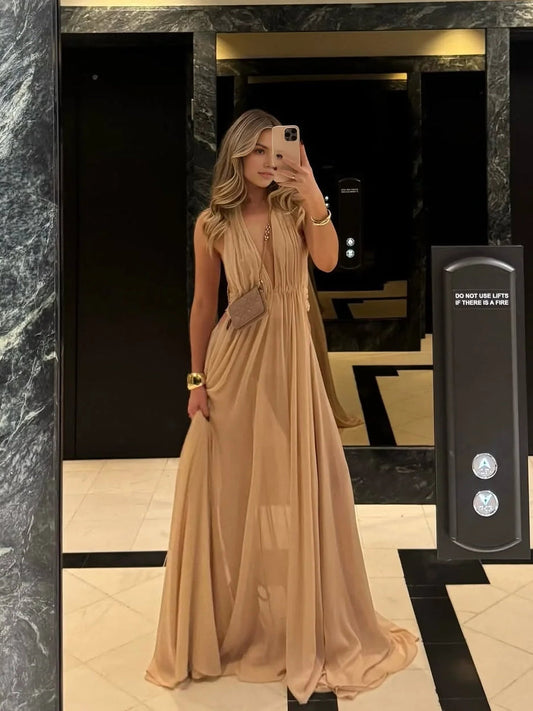 Champagne sleeveless V-neck maxi dress with pleated bodice and full flowing skirt