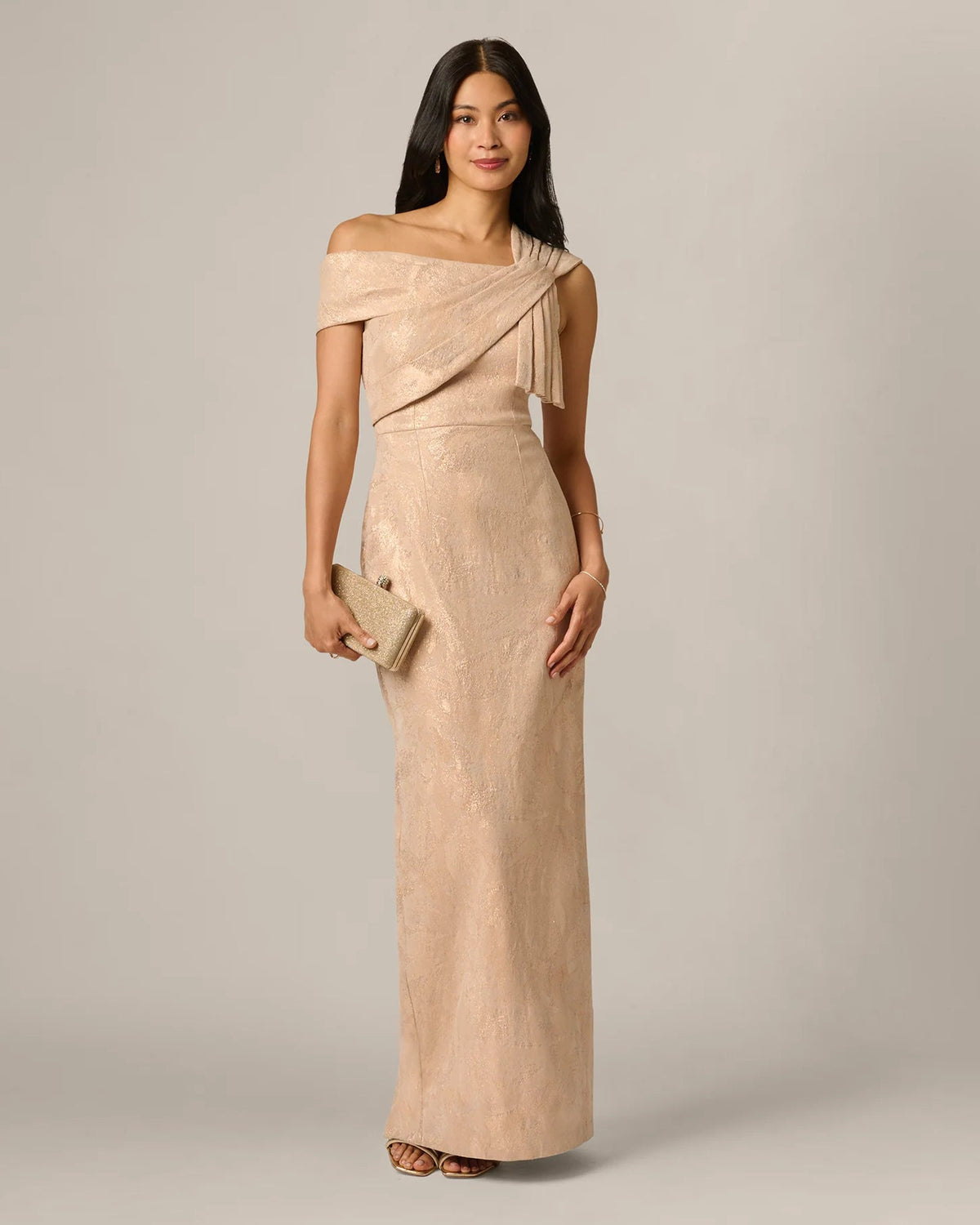 Champagne shimmer sheath maxi dress with diagonal wrap sash and off-shoulder bow accent