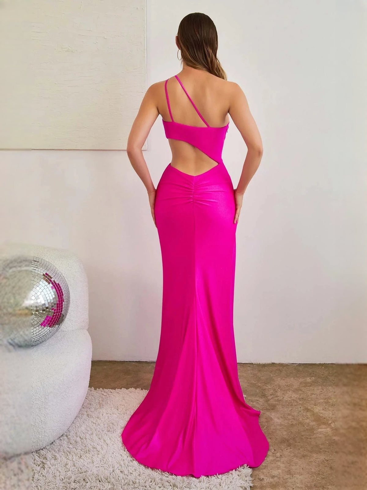 Hot pink one-shoulder formal dress with open back and floor-length mermaid skirt