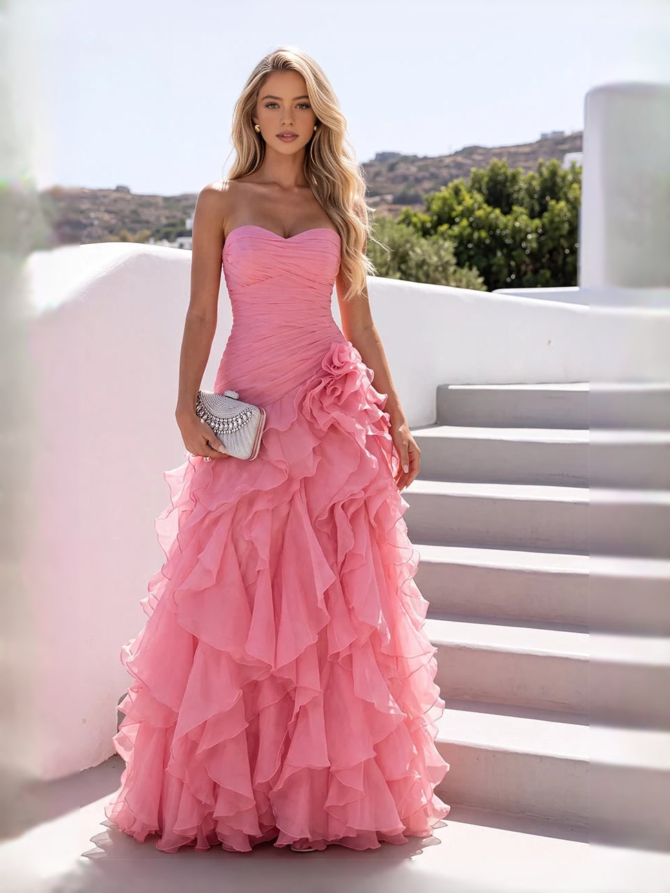 Light pink strapless ruched chiffon prom dress with cascading ruffles and A-line hem