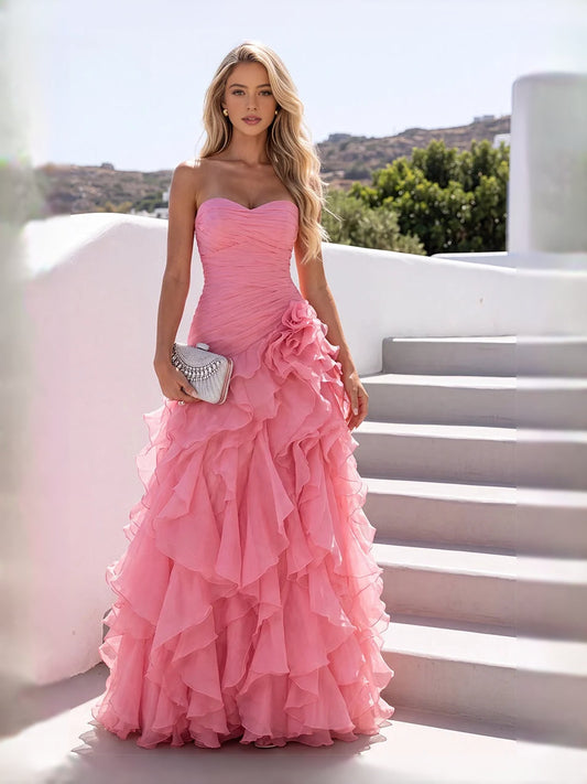 Light pink strapless ruched chiffon prom dress with cascading ruffles and A-line hem