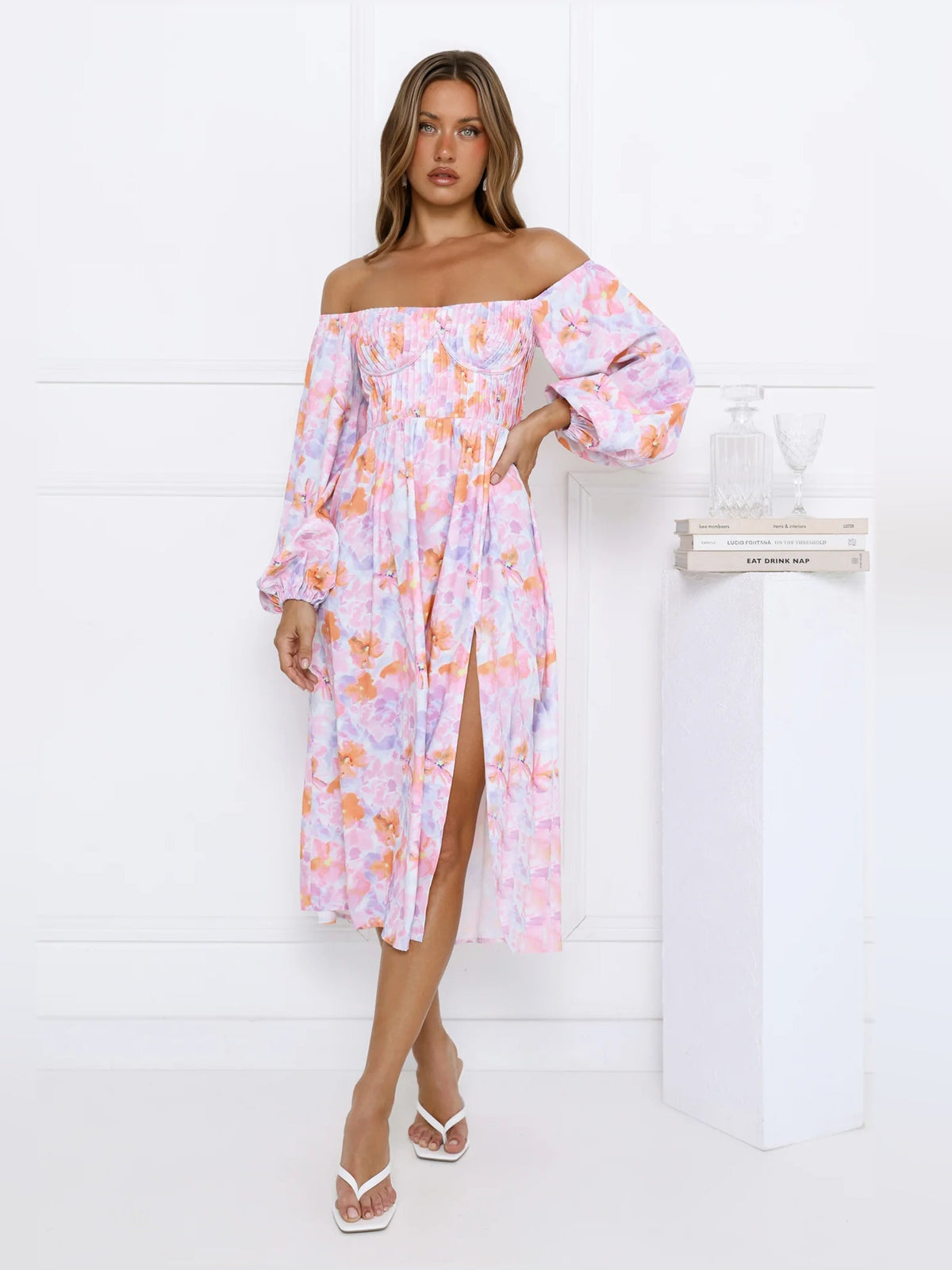 Floral off-shoulder midi dress with puff sleeves and front slit in pastel tones.