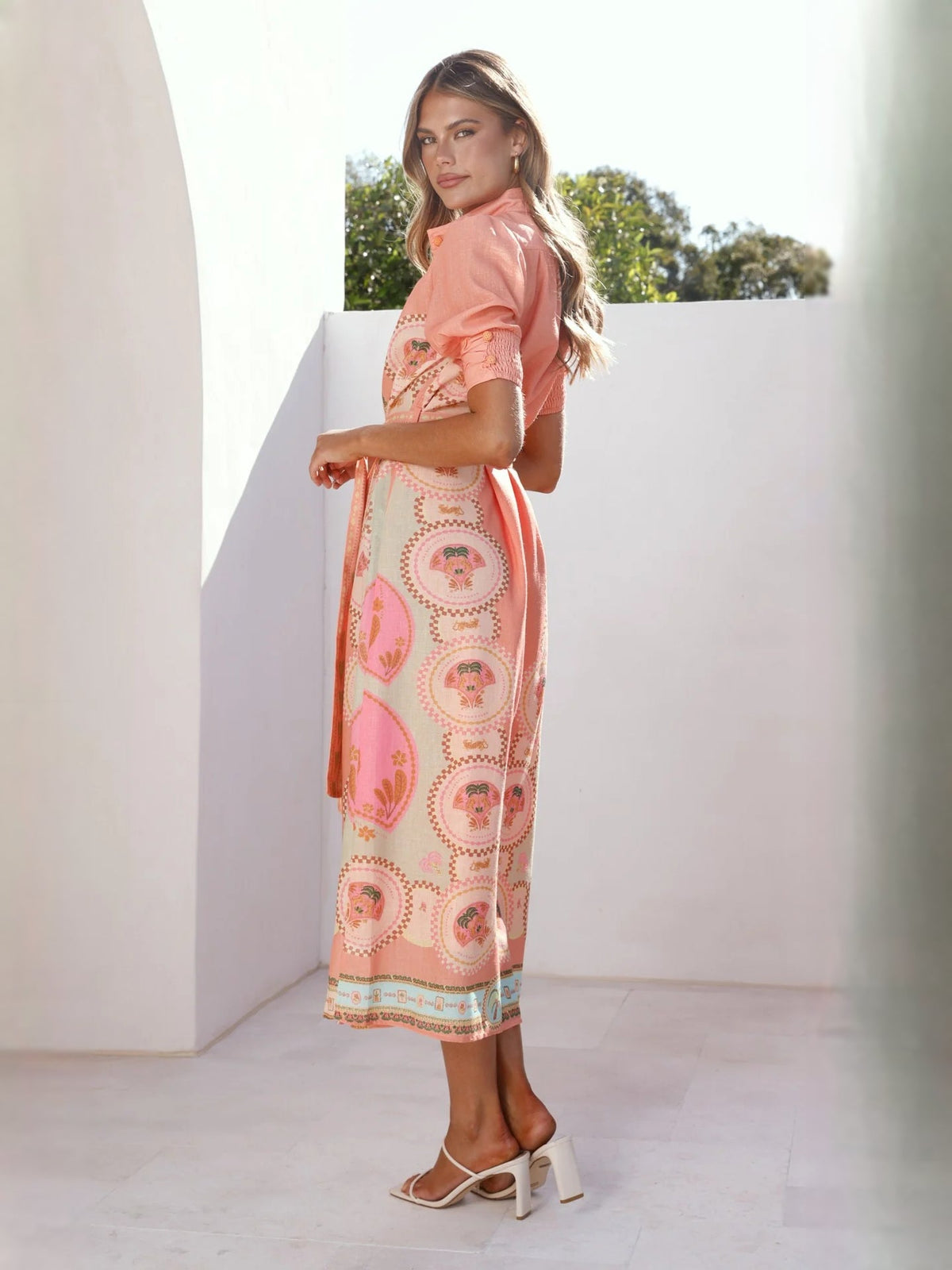Peach midi formal dress with medallion print, puff sleeves, and tie waist sash