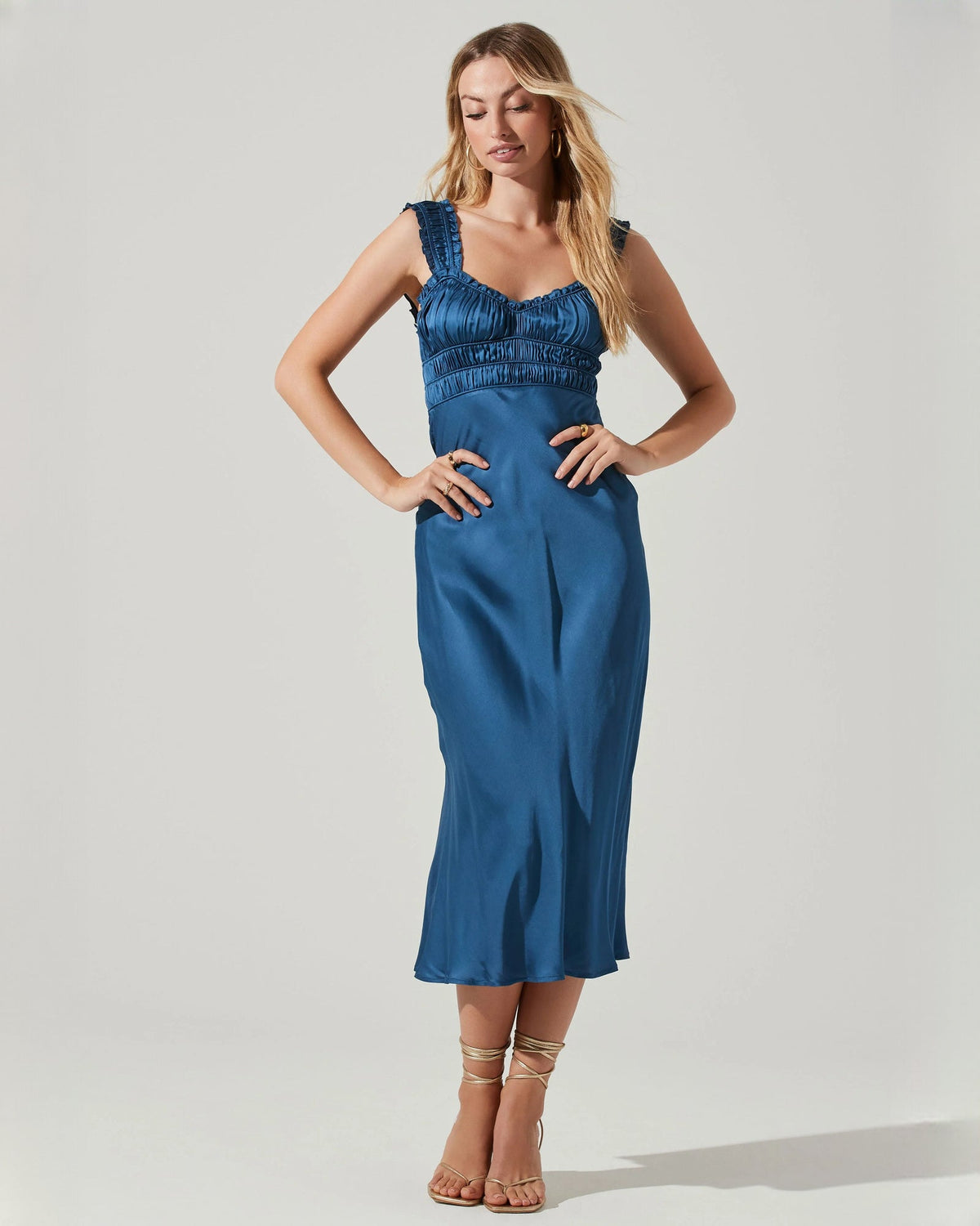 Blue satin sleeveless midi dress with ruched neckline and thin straps, A-line.