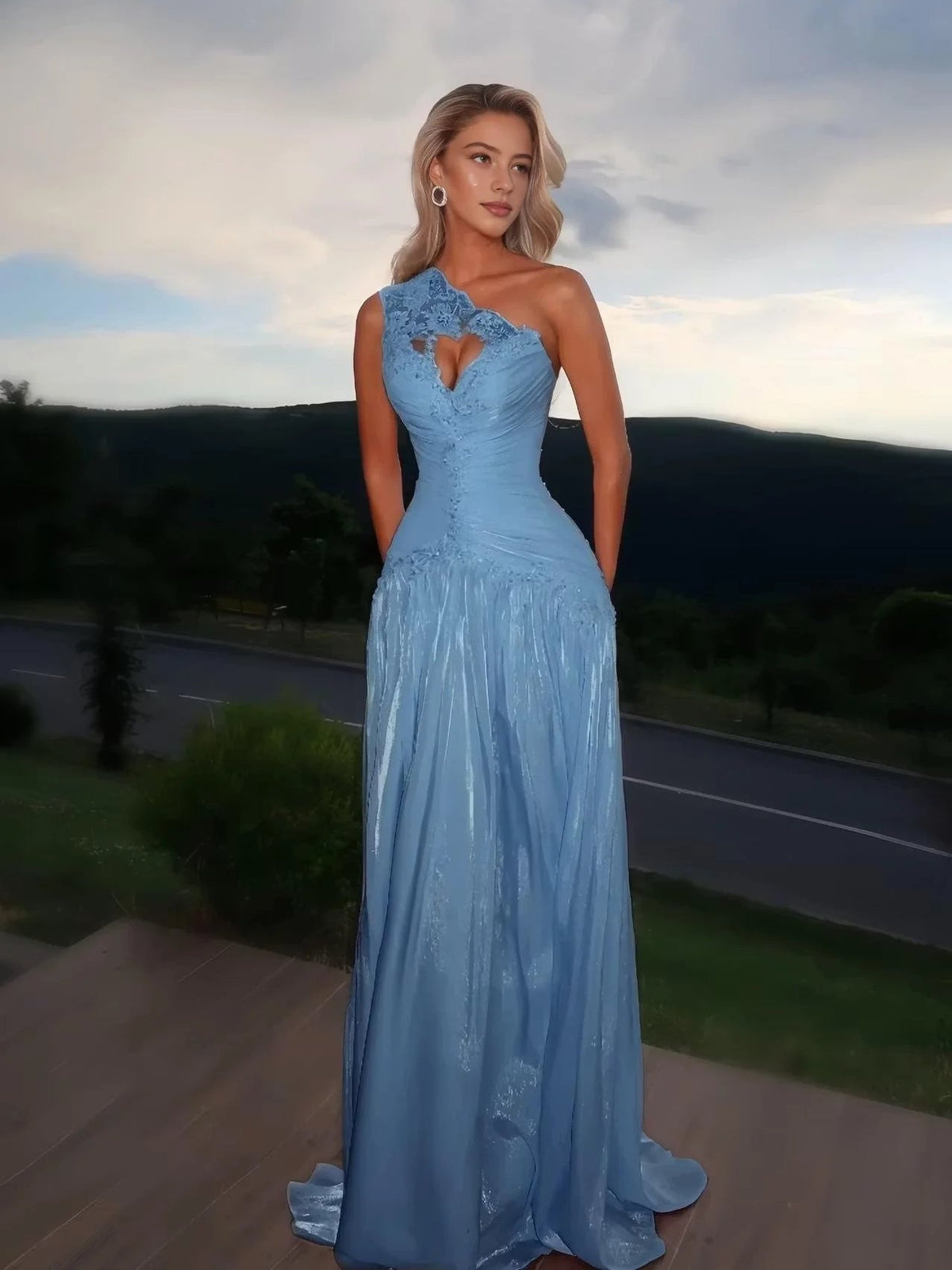 Light blue one-shoulder prom dress with ruched bodice, floral heart applique, and A-line maxi skirt
