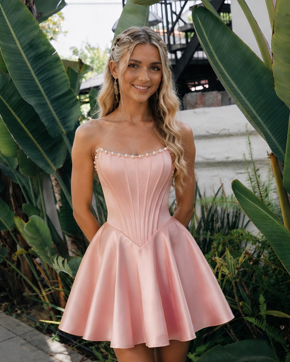Blush pink satin strapless corset dress with pearl trim and flared homecoming skirt
