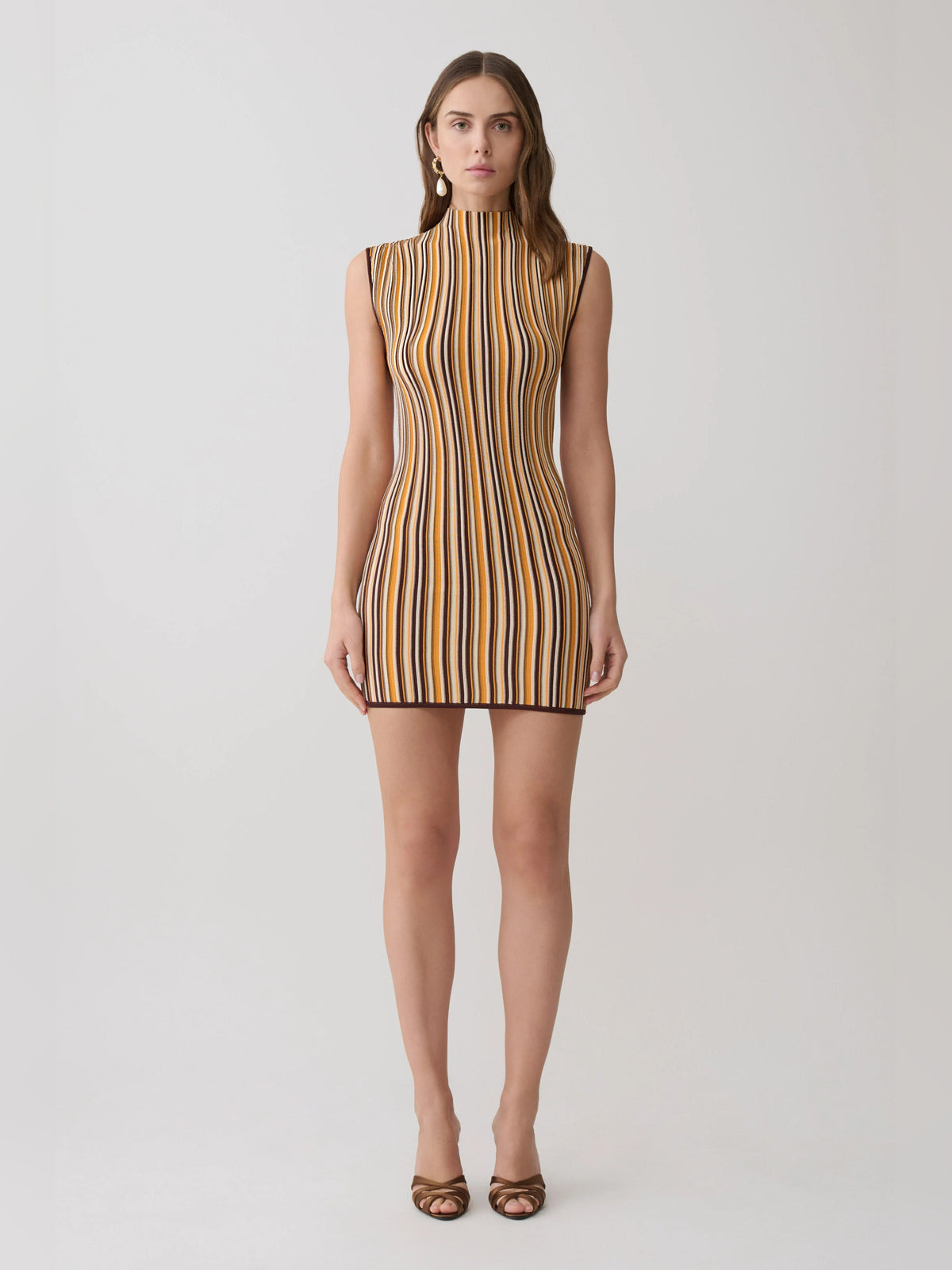 Sleeveless mini dress full front view, vertical stripes in brown and cream with dark accents