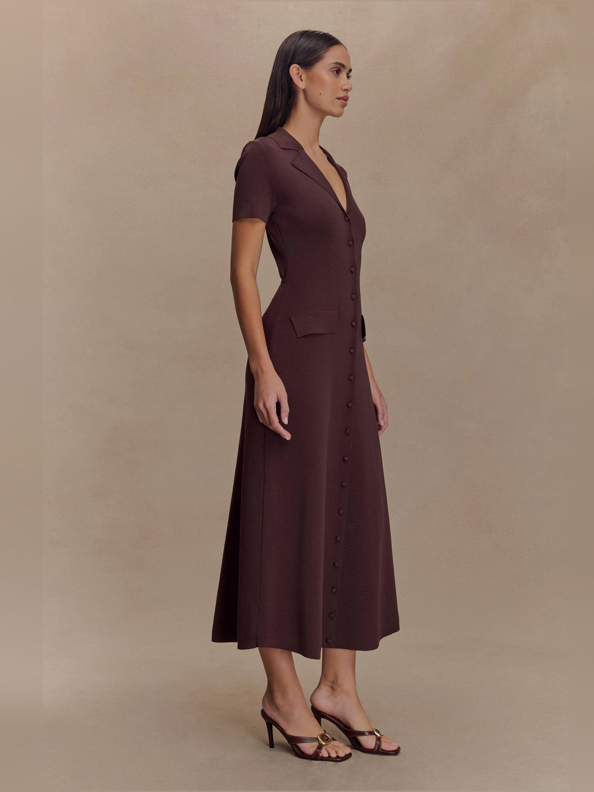 Side view of chocolate-brown knit midi dress with V-neck, short sleeves, and front buttons
