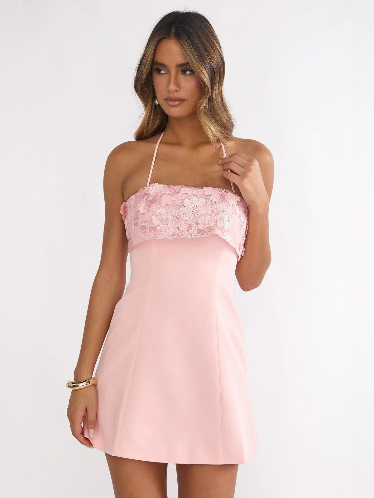 Blush mini homecoming dress with floral lace ruffle bodice, close front view
