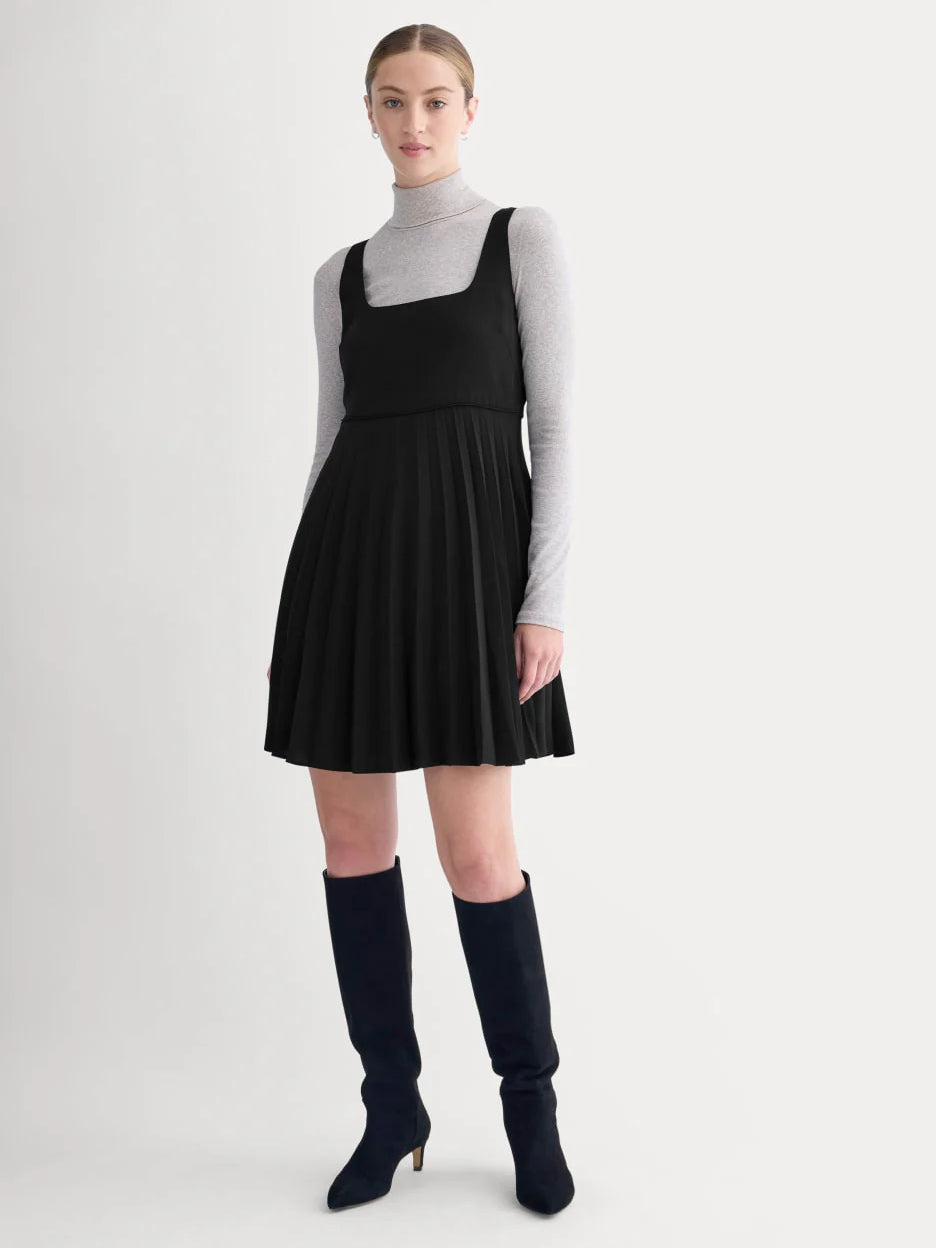 Black sleeveless mini dress with pleated skirt and scoop neckline