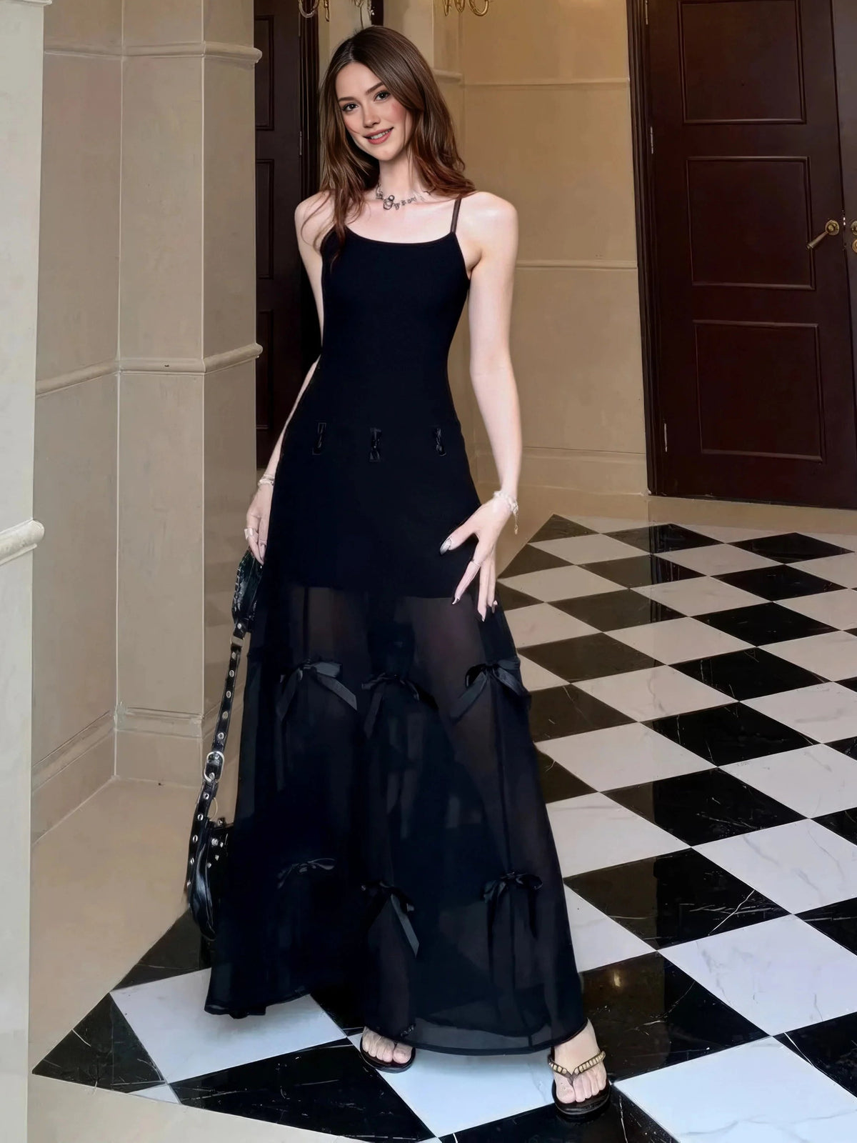 Black A-line maxi prom dress with scoop neck, spaghetti straps, bow-accented tiered skirt