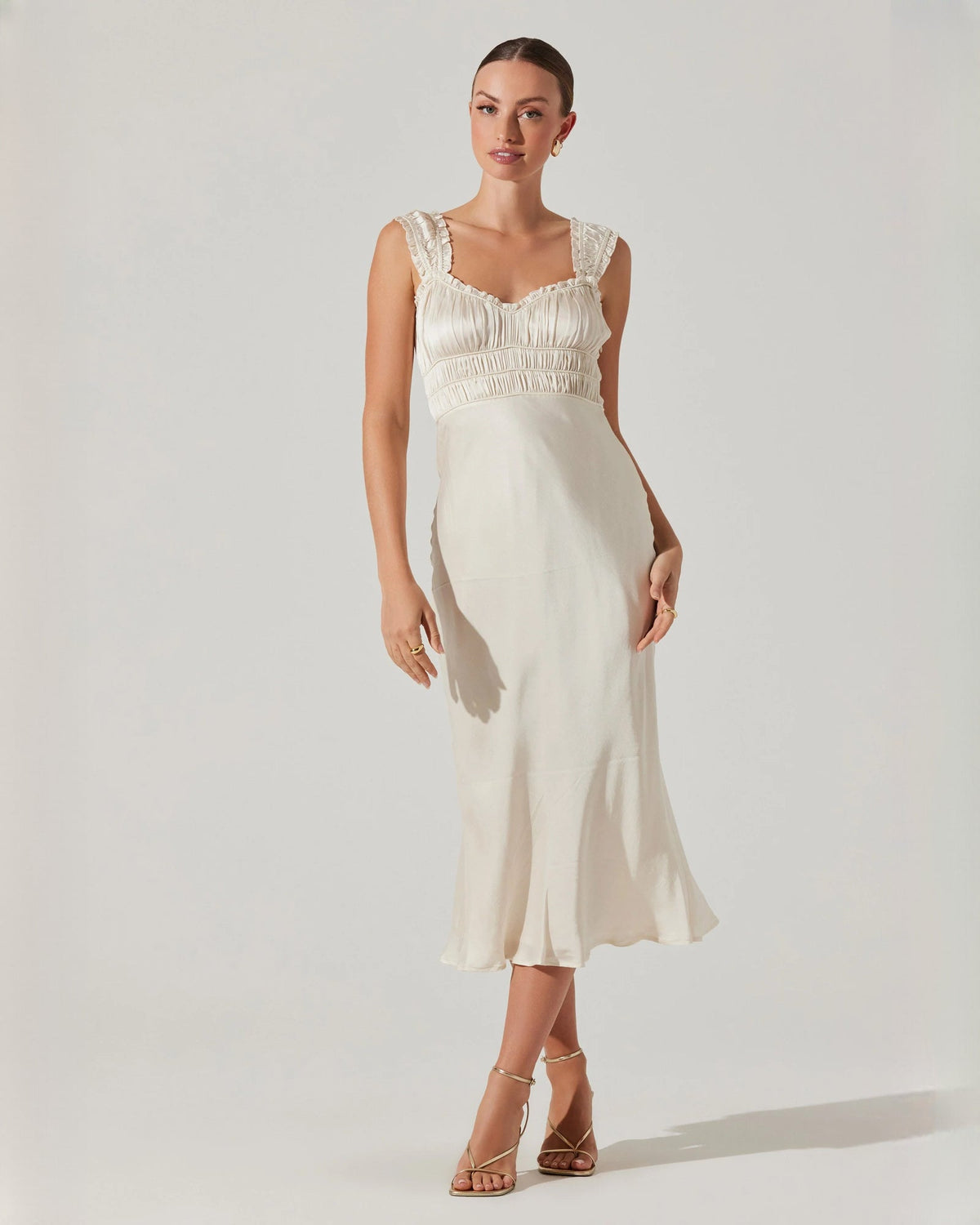 Ivory satin sleeveless midi dress with square neckline and ruched bodice detail.