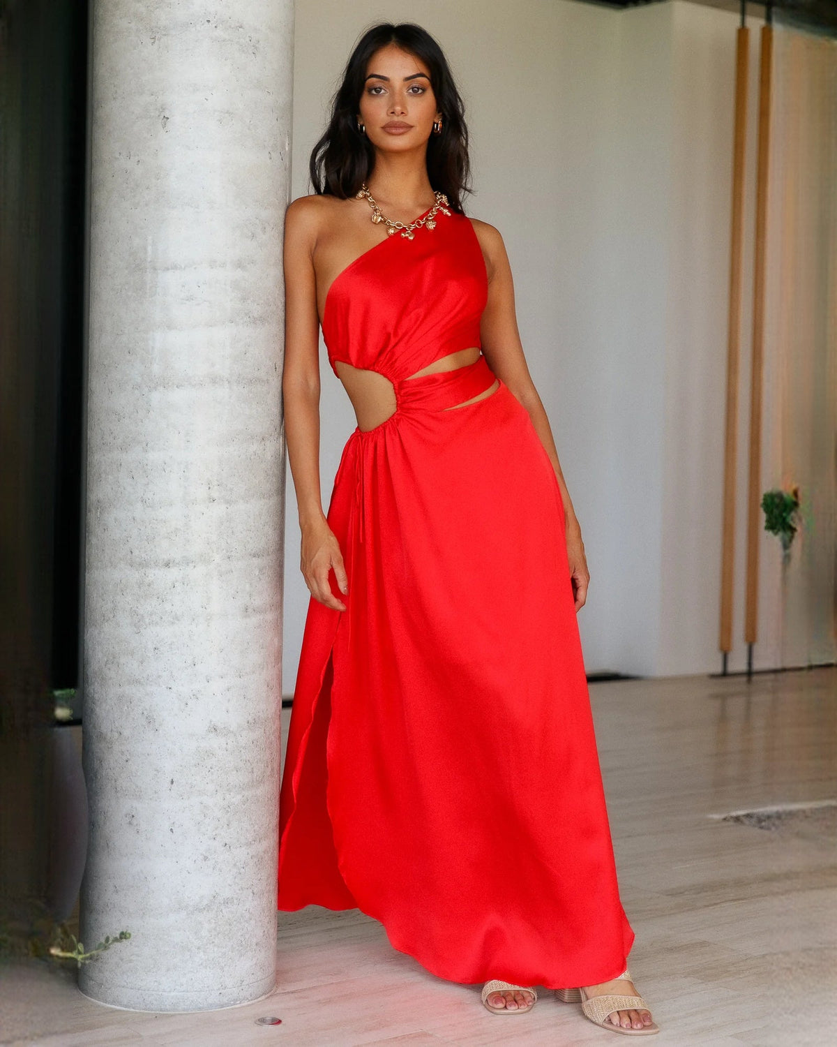 Red satin sleeveless A-line maxi bridesmaid dress with draped waist knot and thigh slit.