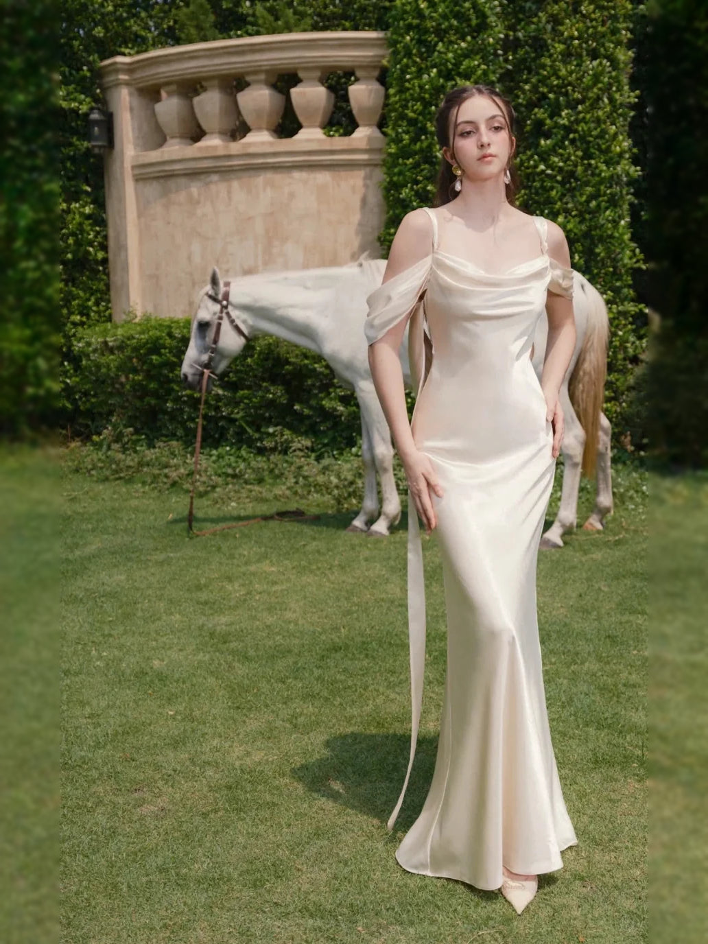 Ivory satin sheath wedding dress with draped cowl neckline and fitted floor-length hem