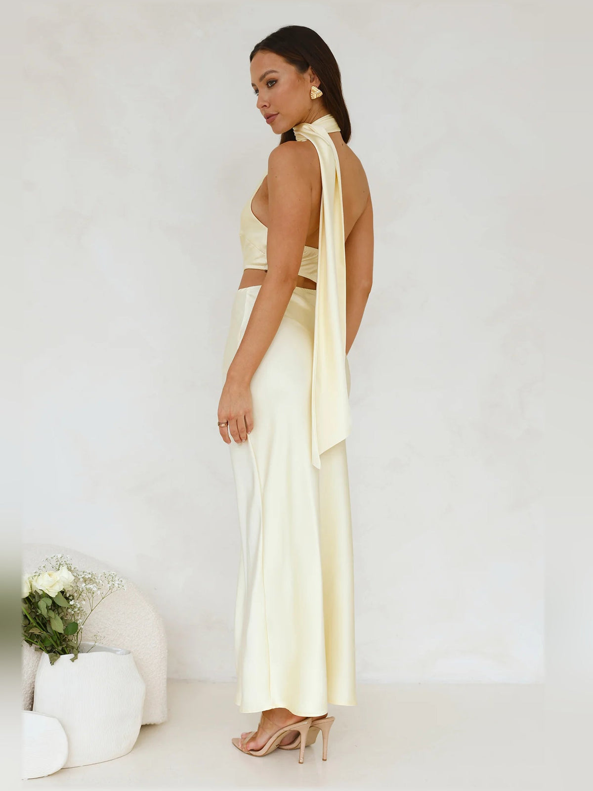 Cream satin midi dress with halter neckline and open back drape