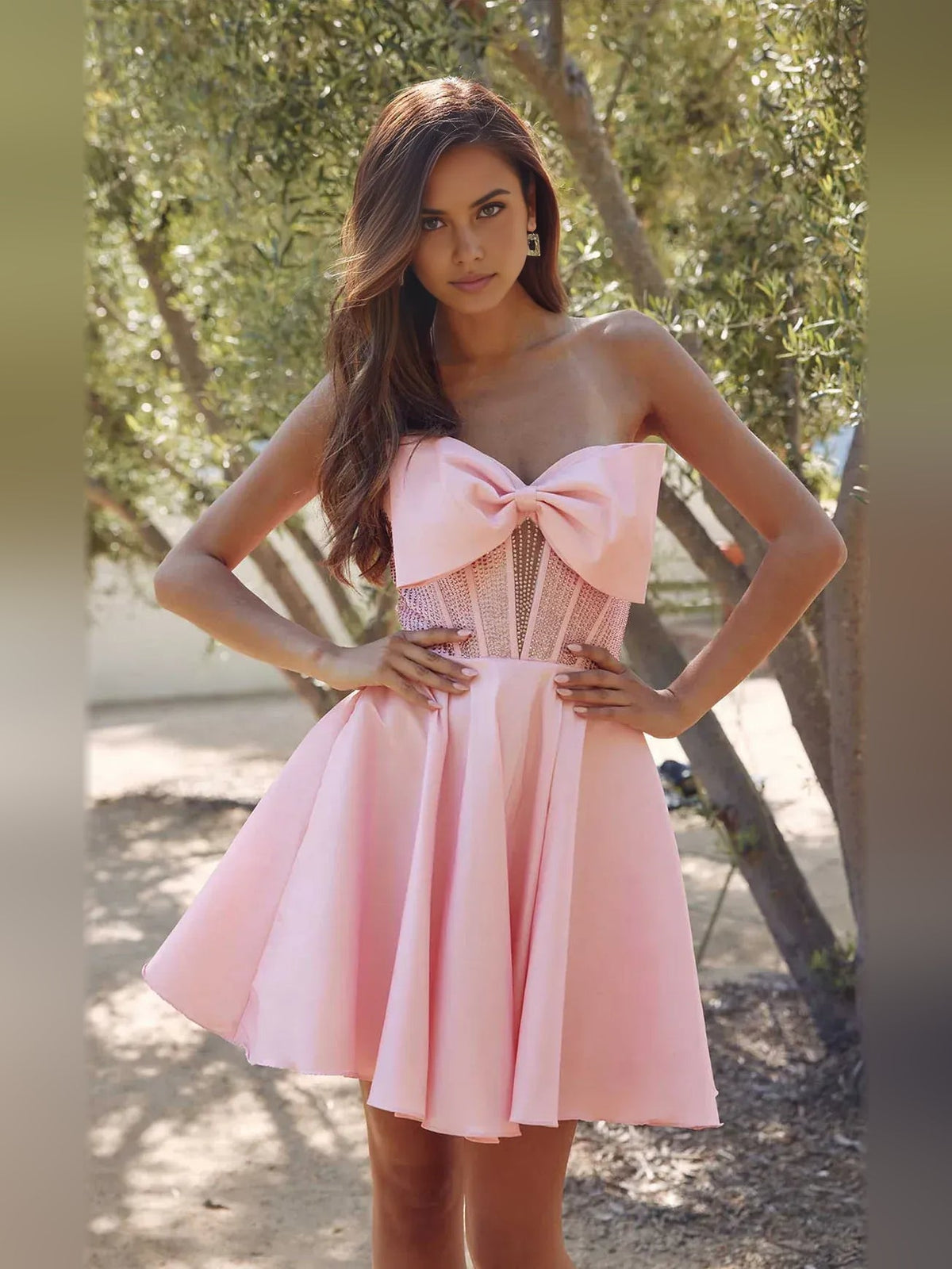 Light pink strapless satin mini dress with corset bodice, pleated A-line skirt, bow